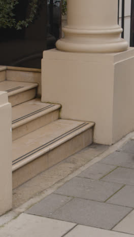 Vertical-Video-Close-Up-Of-People-Walking-Past-Buildings-In-Grosvenor-Street-Mayfair-London